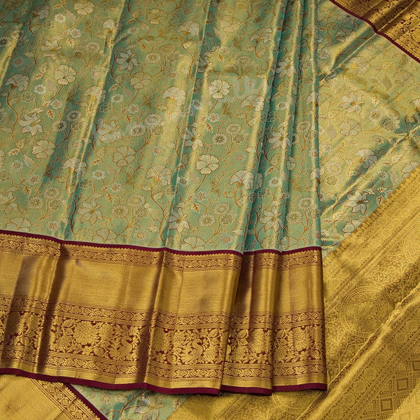 Green Tissue Silk Saree With Floral Design And Gold Zari Border