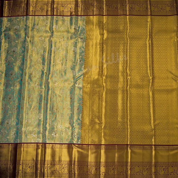 Green Tissue Silk Saree With Floral Design And Gold Zari Border