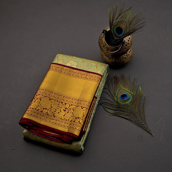 Green Tissue Silk Saree With Floral Design And Gold Zari Border