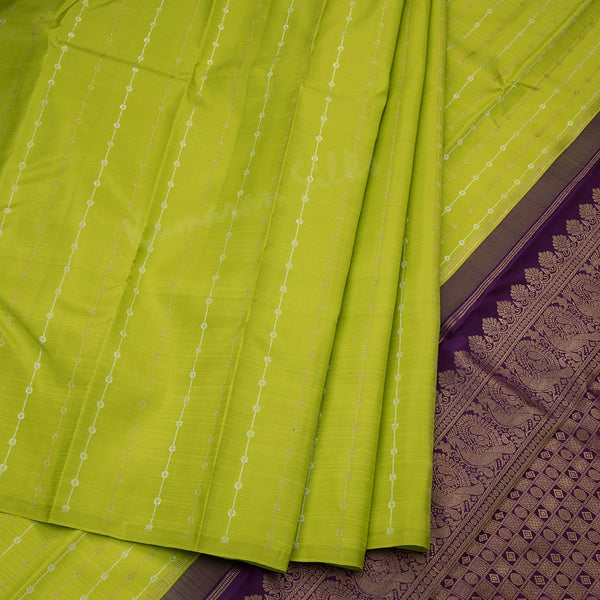Green silk saree with vertical gold and silver zari design and contrast pallu