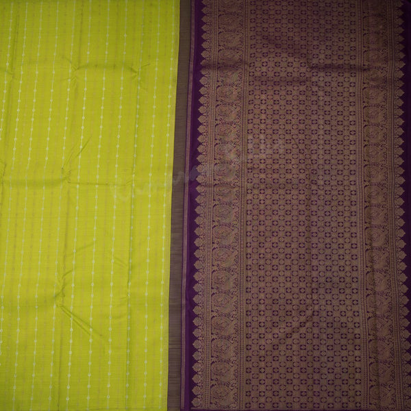 Green silk saree with vertical gold and silver zari design and contrast pallu