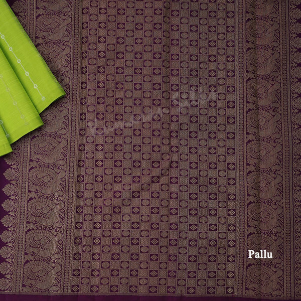 Green silk saree with vertical gold and silver zari design and contrast pallu