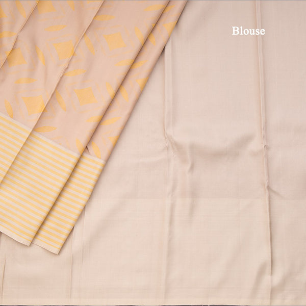 Beige Silk Saree With Stylish Yellow Patterns Adorning The Body And Grey Zari Border