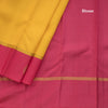 Lemon Yellow Embossed Kanchipuram Silk Saree With Contrast Pink Border