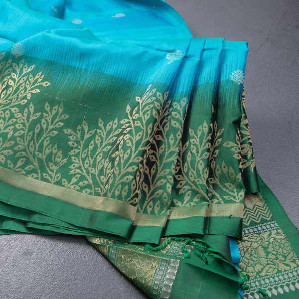 Rama Blue Soft Silk Saree With Tiny Buttis On Body And Green Leaves Patterned Border