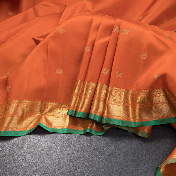 Rust Orange Silk Saree With Peacock And Chakra Buttas And Gold Zari Border