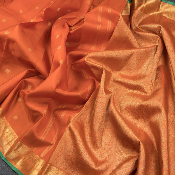 Rust Orange Silk Saree With Peacock And Chakra Buttas And Gold Zari Border