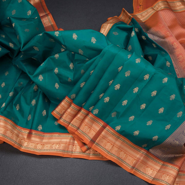 Peacock Green Soft Silk Saree With Peacock Buttas On The Body And Orange Zari Border