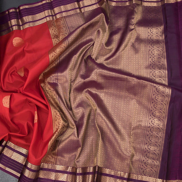 Red Silk Saree With Chakra Buttas On The Body And Purple Zari Border