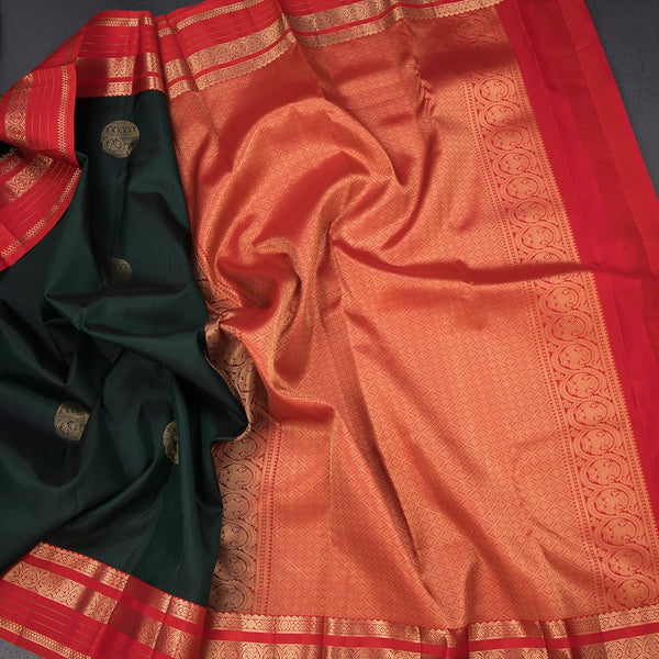 Bottle Green Silk Saree With Chakra Buttas On The Body And Red Zari Border