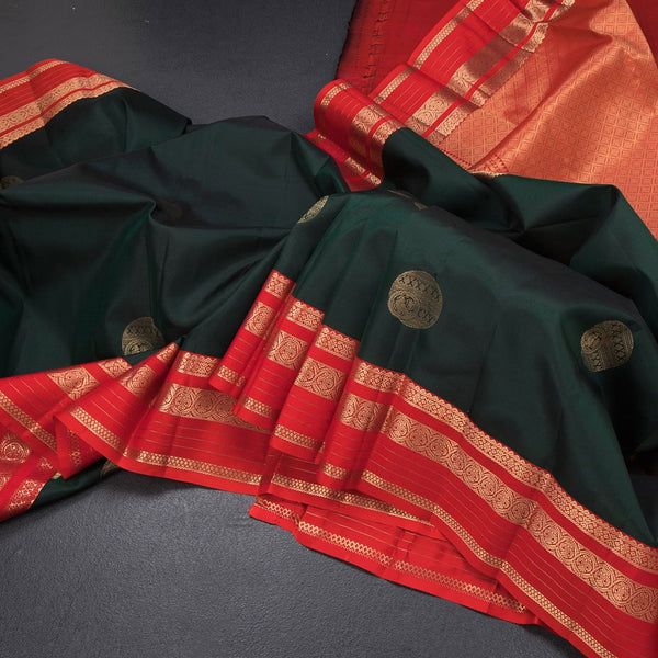 Bottle Green Silk Saree With Chakra Buttas On The Body And Red Zari Border
