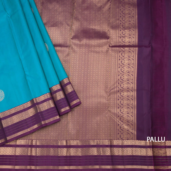 Peacock Blue Silk Saree With Chakra Buttas On The Body And Purple Zari Border