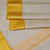 Biscuit Colour Silk Dhoti With Mayil Kannu Yellow Border - Kumaran Silks