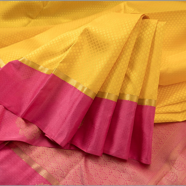 Lemon Yellow Embossed Kanchipuram Silk Saree With Contrast Pink Border