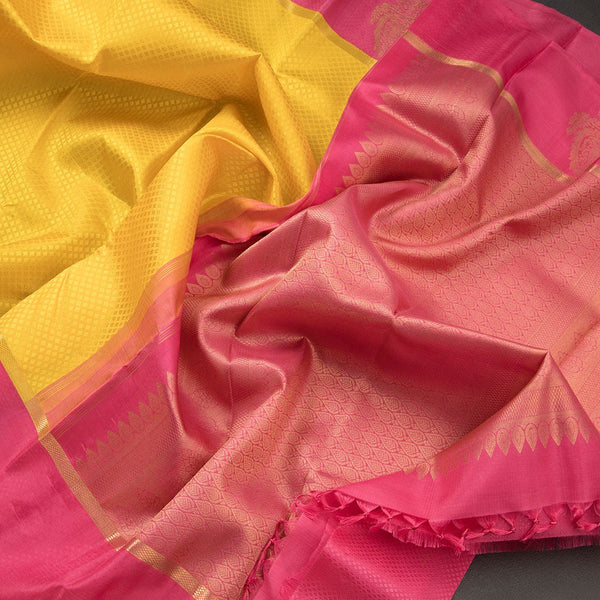 Lemon Yellow Embossed Kanchipuram Silk Saree With Contrast Pink Border