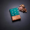 Peacock Green Soft Silk Saree With Peacock Buttas On The Body And Orange Zari Border