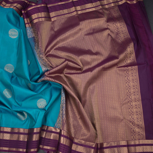 Peacock Blue Silk Saree With Chakra Buttas On The Body And Purple Zari Border