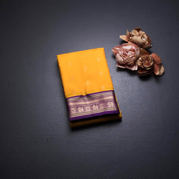 Mango Yellow Soft Silk Saree With Peacock Buttas On The Body And Purple Zari Border
