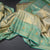 Sea Green Tissue Silk Saree With Floral And Birds Motif And Temple Border