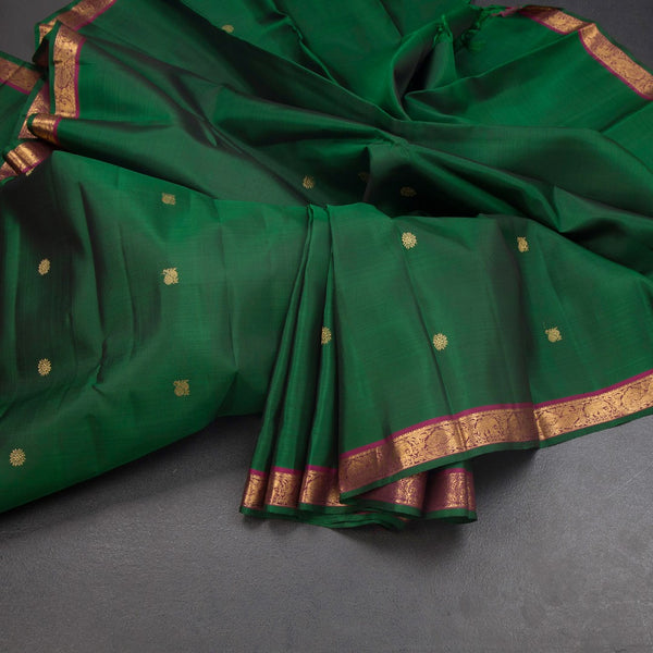 KSSMLSR42347-Dark-Green-Silk-Saree-With-Peacock-And-Chakra-Buttas-And-Zari-Border-main