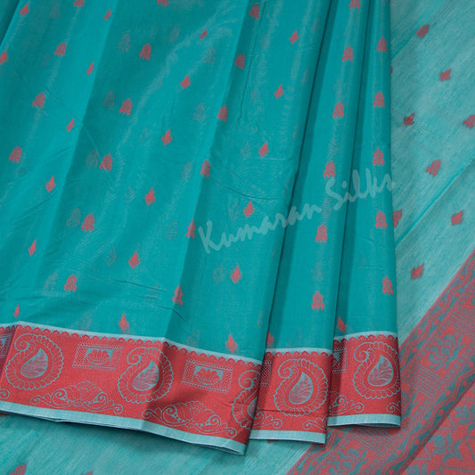 Silk Cotton Teal Blue Embossed Saree With Small Buttas And Red Border