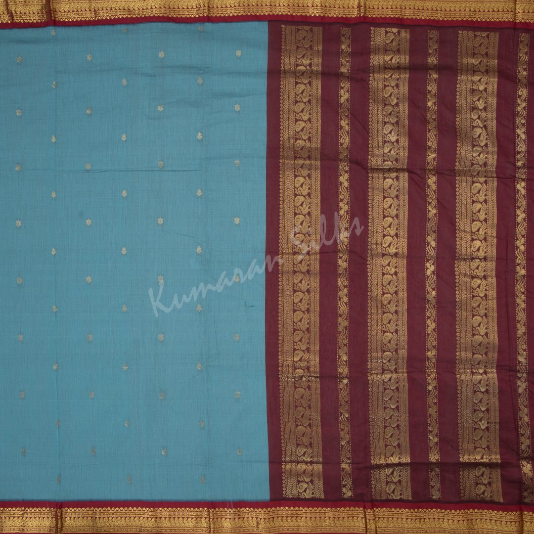 Kalyani Cotton Light Blue Saree With Small Buttas On The Body And Peacock Motif On The Pallu