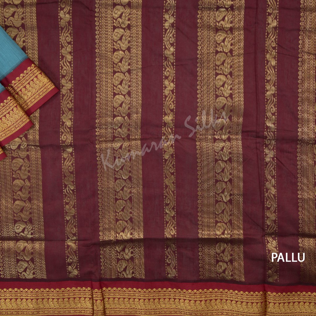 Kalyani Cotton Light Blue Saree With Small Buttas On The Body And Peacock Motif On The Pallu